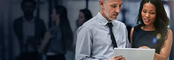 Man and woman looking at a tablet together